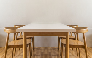 White table in white room and wooden floor.