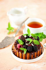 Cake in chocolate glaze with berries. Selective focus. Sweet summer dessert.