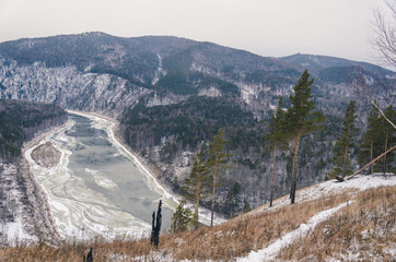 Autumn and winter landscape, the mountain and the river freezes