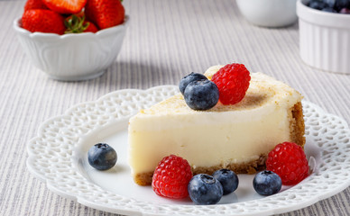 Delicious cheesecake with strawberry and blueberry on a table top view.