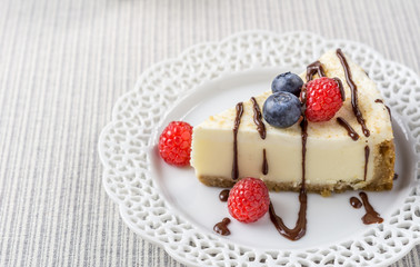 Delicious cheesecake with strawberry and blueberry on a table top view.