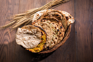 Assorted Indian Bread Basket includes chapati, tandoori roti or naan, paratha, kulcha, fulka, missi roti   © StockImageFactory