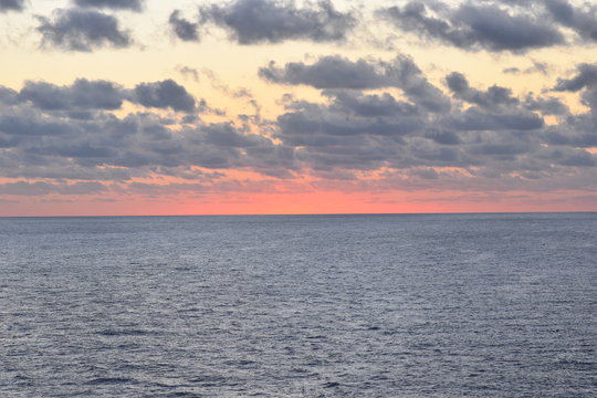 The Clouds and Sun Rising over the Ocean