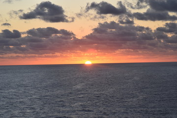 The Clouds and Sun Rising over the Ocean