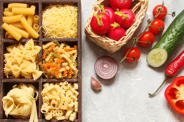 Pasta with vegetables, spices and herbs in wooden cells