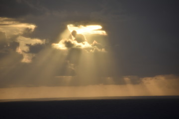 Sun Rays Peering from Dark Clouds