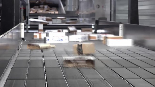 Huge amount of parcels bein transported on conveyor belts with motion blur