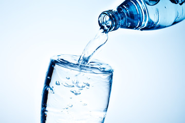Fresh drinking water is poured in a glass.