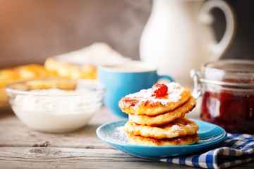 Delicious pancakes on wooden table with Cup of coffee and jam