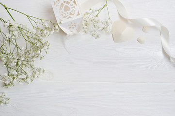 Mock up Composition of white flowers rustic style, hearts and a gift for St. Valentine's Day with a...