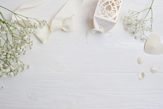 Mock up Composition of white flowers rustic style, hearts and a gift for St. Valentine's Day with a place for your text. Flat lay, top view photo mock up