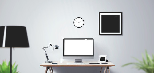 Computer display and office tools on desk.