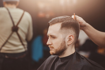 Barbershop. Barber shears client with hair machine.