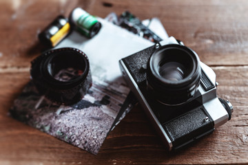 Retro photo camera on a stylish wooden background with different photo related items