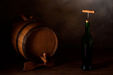  a small wooden wine bar, barrel on the legs and a wooden crane on a wooden background with a glass...