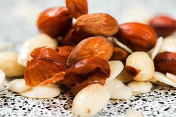  Heap of peeled and unpeeled almonds.