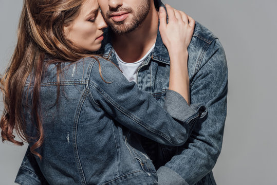 cropped shot of seductive young couple hugging isolated on grey