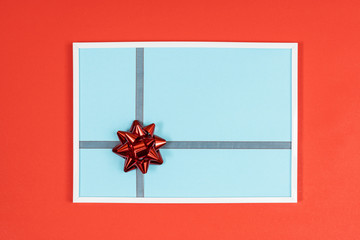 Christmas decorative bow in a white frame on a colored background	