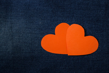 Obraz premium Two red hearts heart on denim background. Background Valentine's Day.