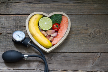 Health heart diet food concept with blood pressure gauge