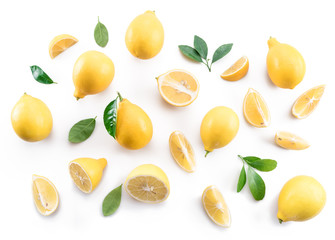 Ripe lemons and lemon leaves on white background. Top view.