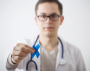 male doctor in white coat with sky blue prostate cancer awareness ribbon