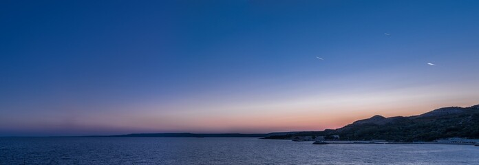 Calm sea and cloudless evening sky. Nature background.