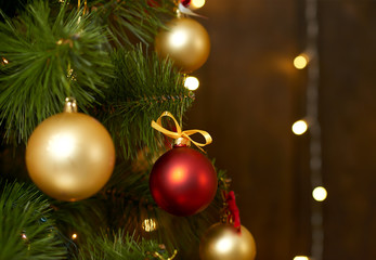 Fototapeta na wymiar closeup of christmas tree on wooden background, winter holiday concept