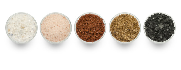 variety of natural and spicy salt on white background