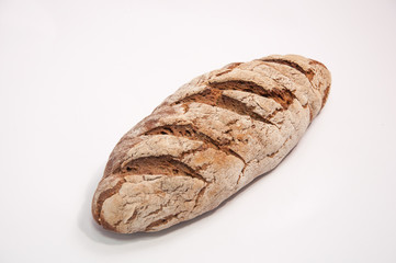 Loaf of fresh baked rustic bread on a white background