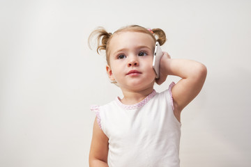 Cute baby girl is talking on cell phone