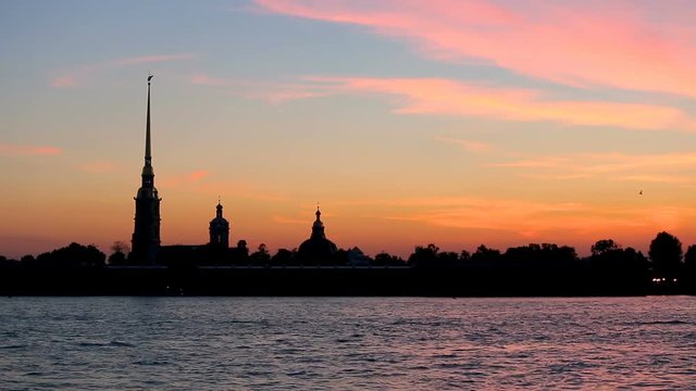 silhouette of Peter and Paul fortress against the backdrop of the setting sun