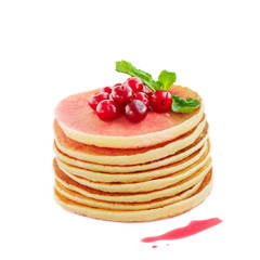 Pancakes with berry syrup on a plate on a white background