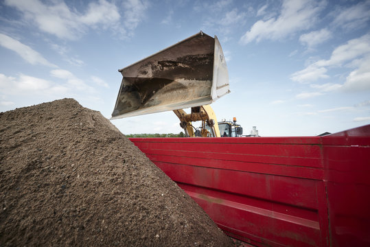 Excavator moving sand and gravel 