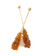 Brown amber sugar crystal on wooden stick isolated