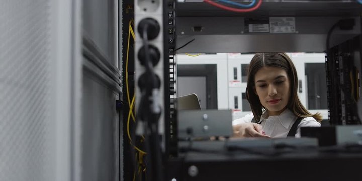 woman using computer in server room