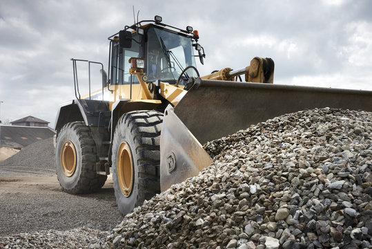 Excavator moving sand