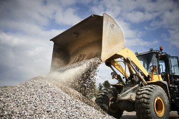 Excavator moving sand