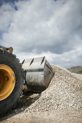 Excavator moving sand