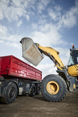 Excavator moving sand