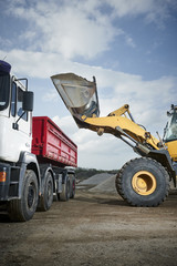 Excavator moving sand