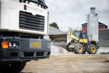 Excavator moving sand