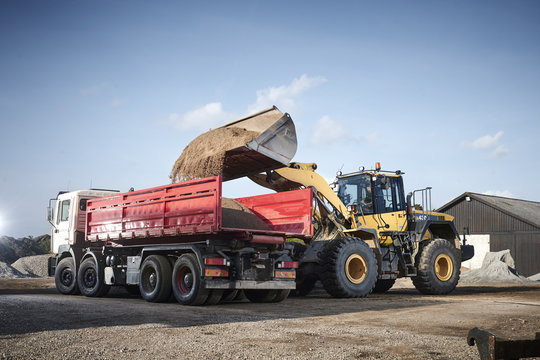 Excavator moving sand