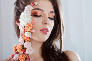 Beautiful young girl with applique flowers on the face.