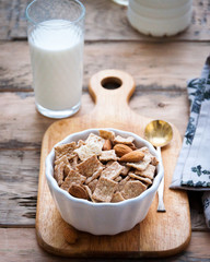 Dry healthy breakfast with nuts and a glass of milk