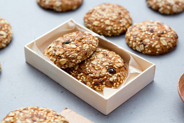 Oats cookies on a white table in rustic style. seeds, basket of fabric for baking. front horizontal view.