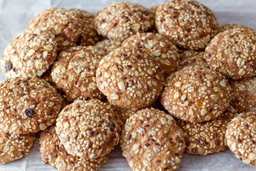 Oats cookies on a white table in rustic style. seeds, basket of fabric for baking. front horizontal view.