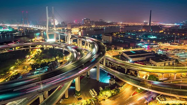 Famous highway intersection in Shanghai, China. Big modern city by night. Time lapse. 