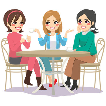 Three beautiful young women friends having coffee sitting at cafe table in street