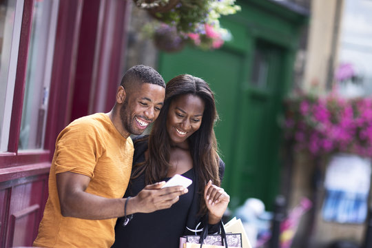 Young Couple Reading A Text Together